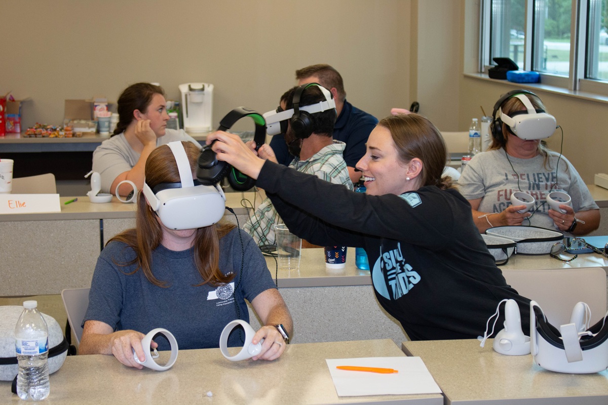 Teachers try virtual reality head sets in a training session