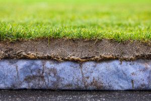 composite layers of a natural grass playing surface