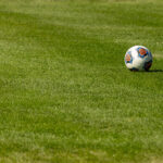 A soccer ball sits on research turf grass.