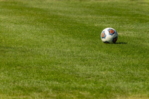 A soccer ball sits on research turf grass.