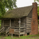 A wooden cabin with a brick fireplace