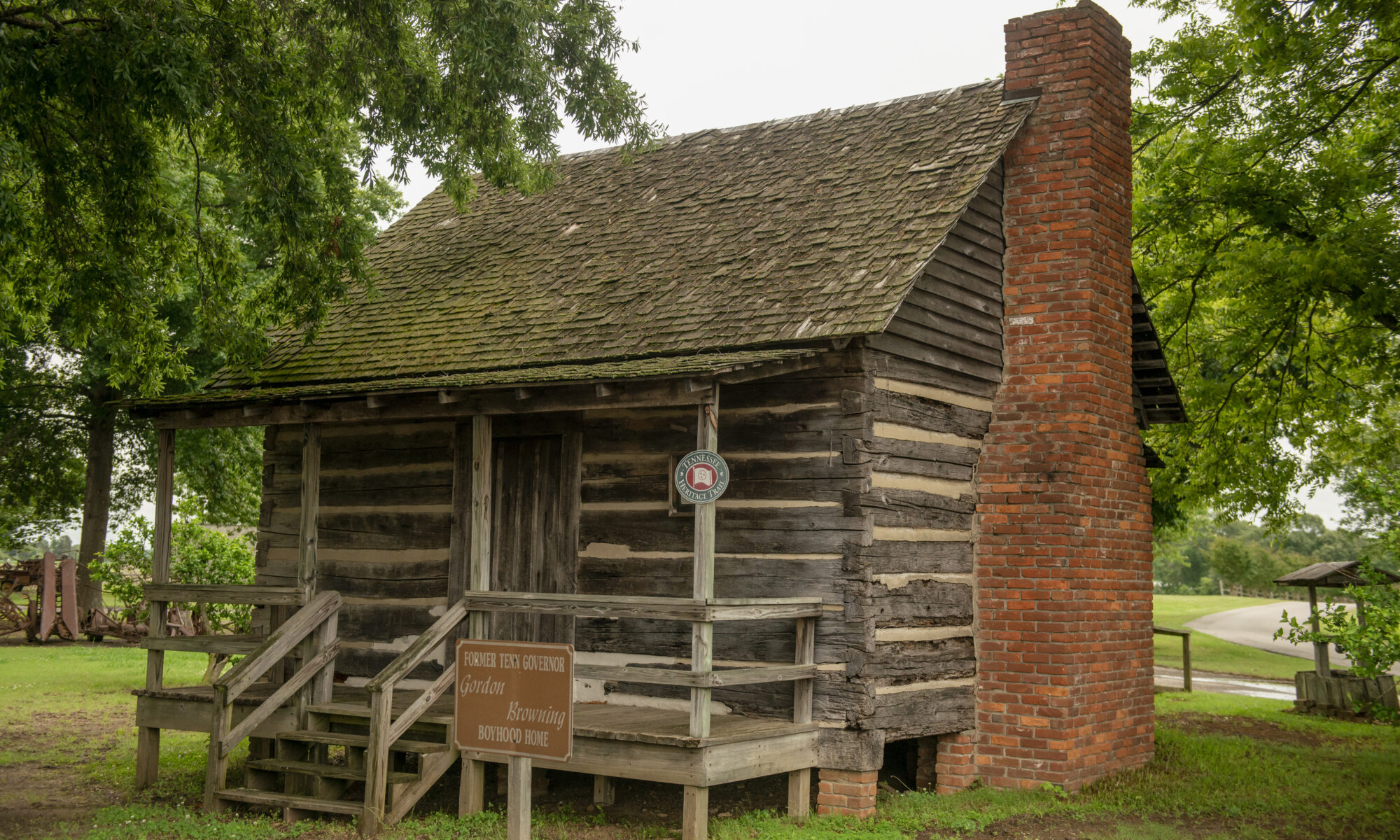 A wooden cabin with a brick fireplace