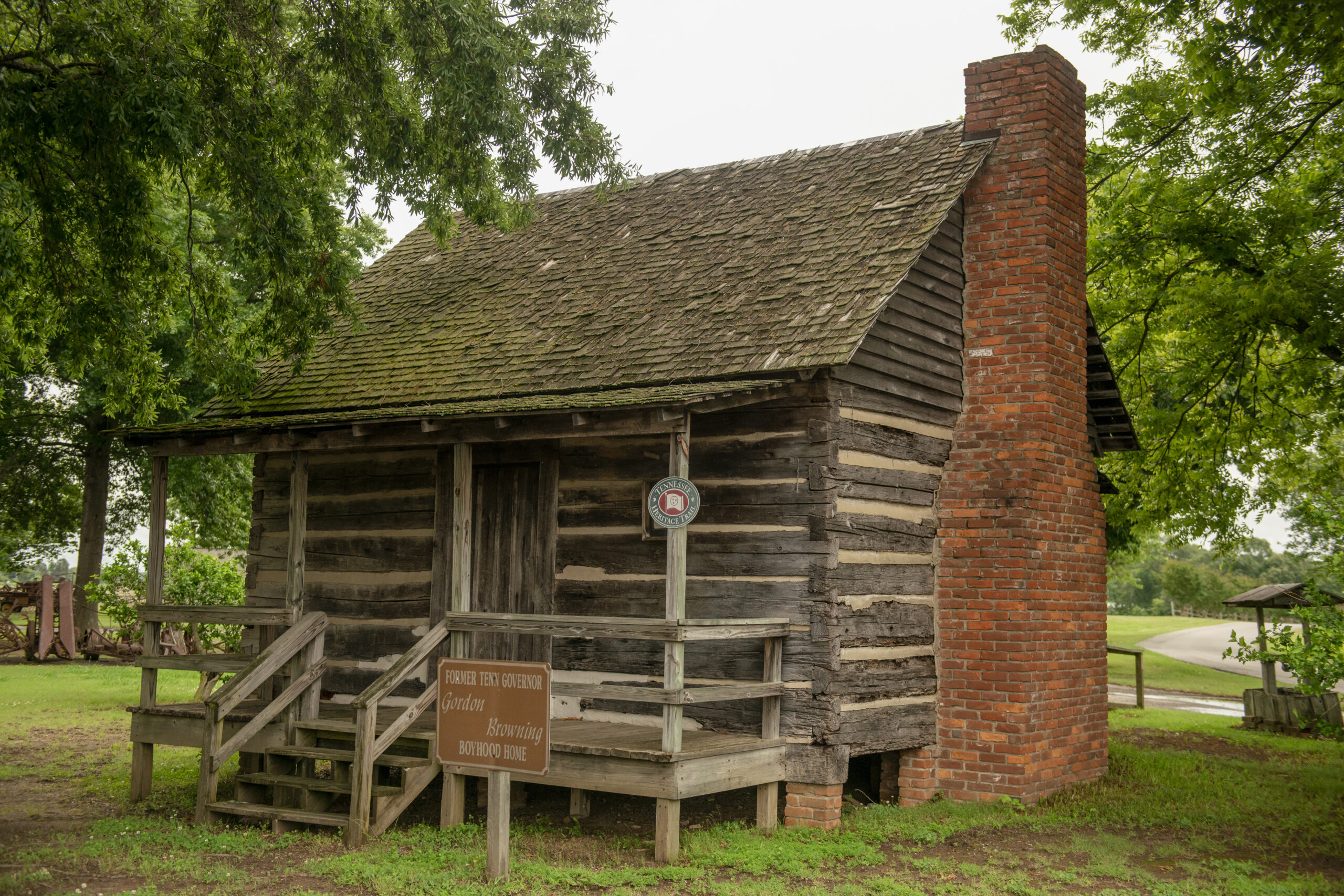 A wooden cabin with a brick fireplace