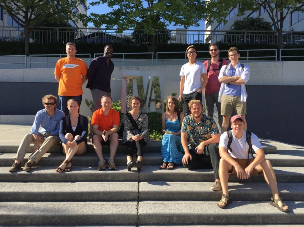 Group of students standing in front of a TVA sign.