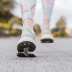 Close-up of a person's shoes as they walk on pavement