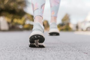 Close-up of a person's shoes as they walk on pavement