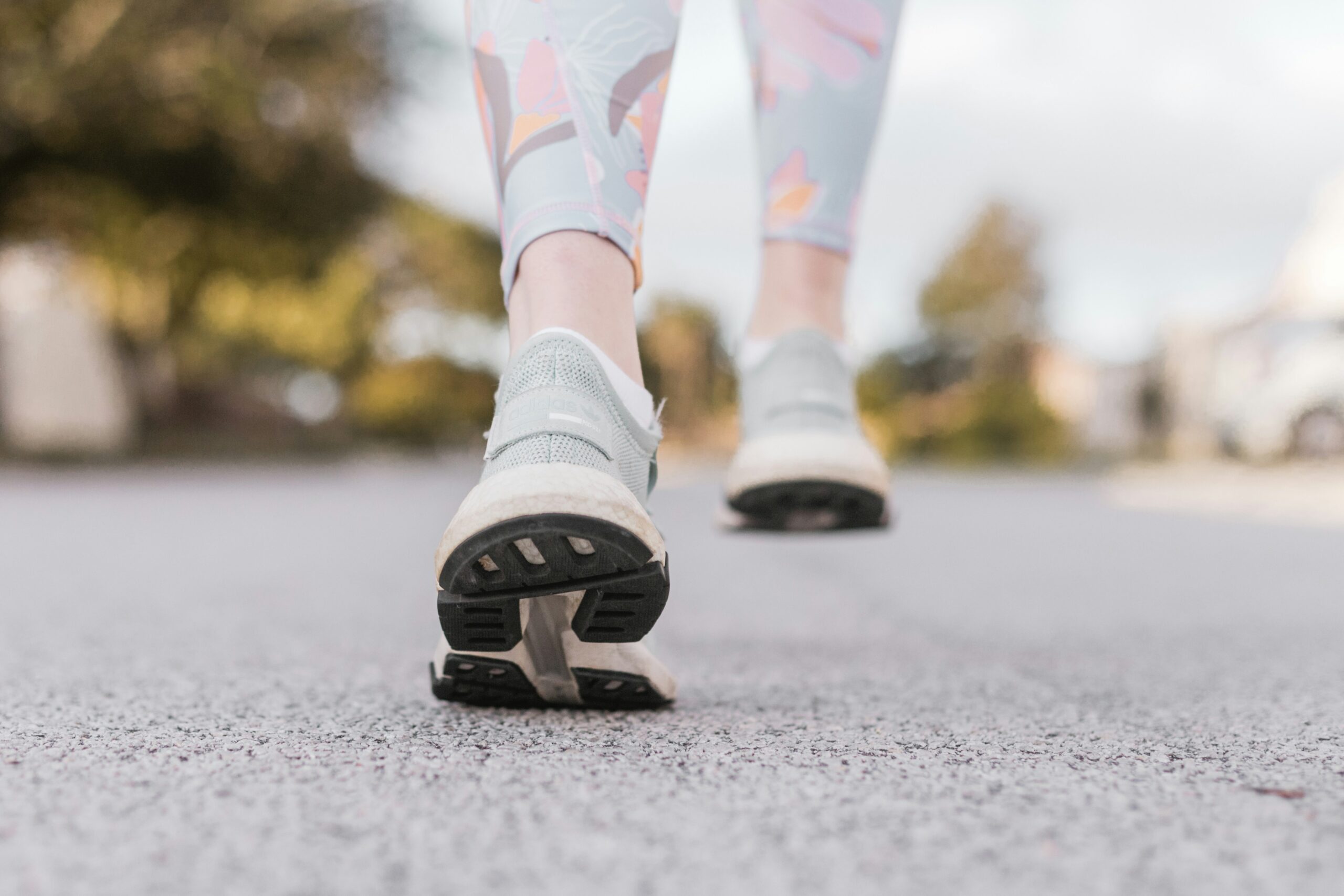 Close-up of a person's shoes as they walk on pavement