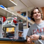 Devin Vitello standing next to a clinostat.