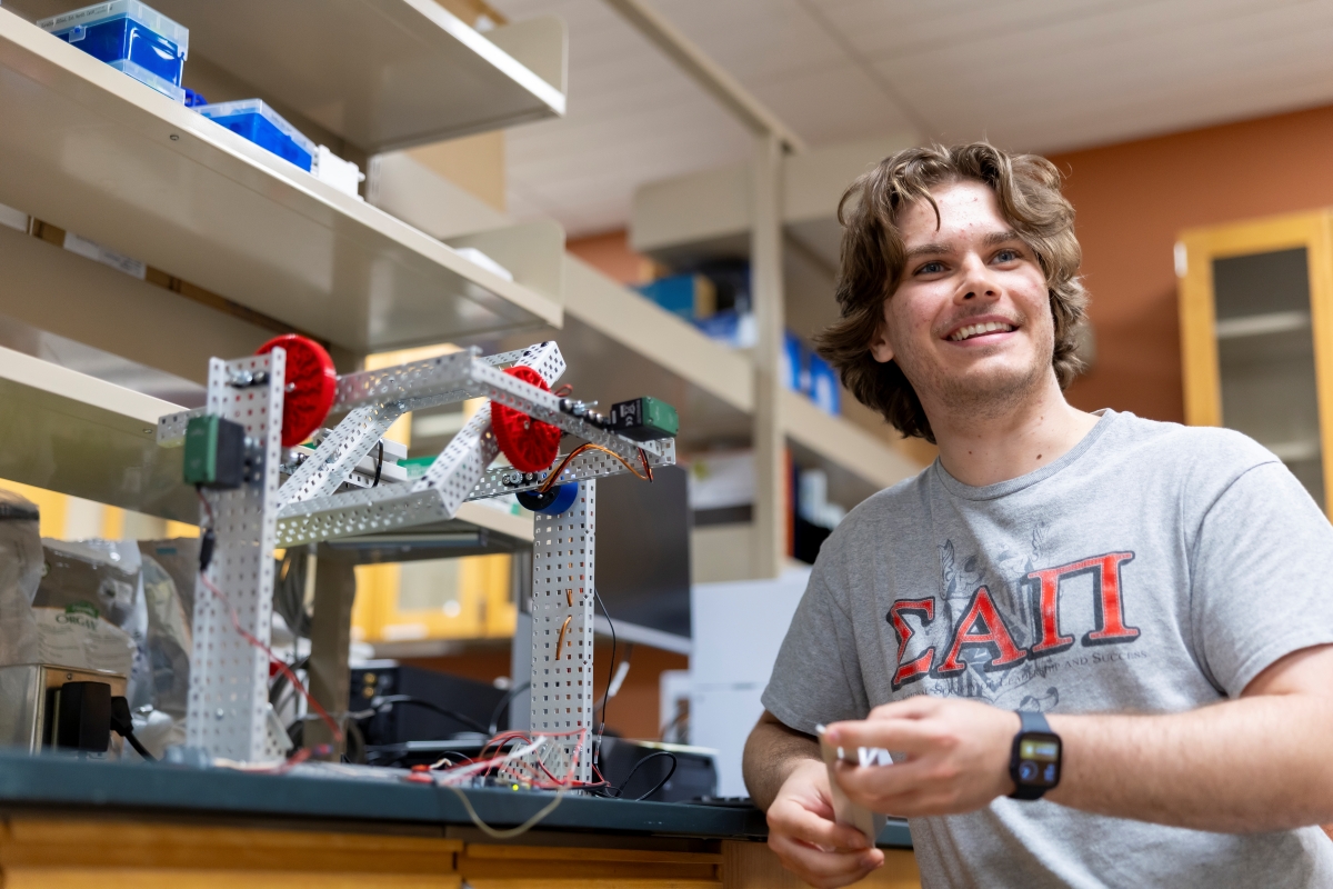 Devin Vitello standing next to a clinostat.